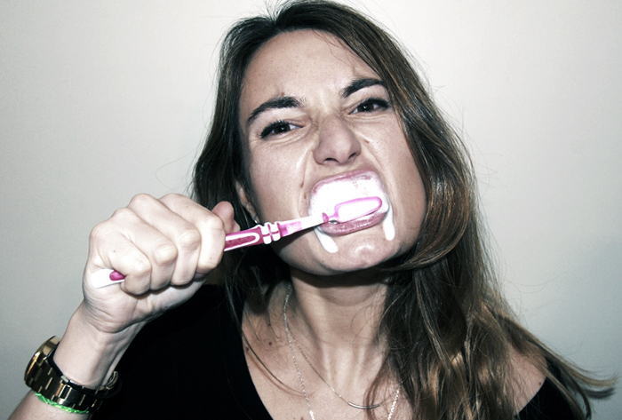 Girl brushing her teeth.